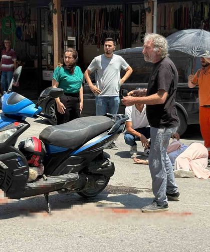 Kazada yaralanan genç kadına esnaftan şemsiyeli destek
