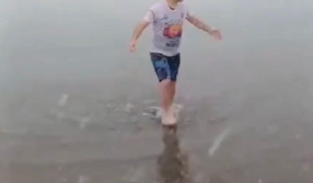 Kar altında denize girip yüzdü attı